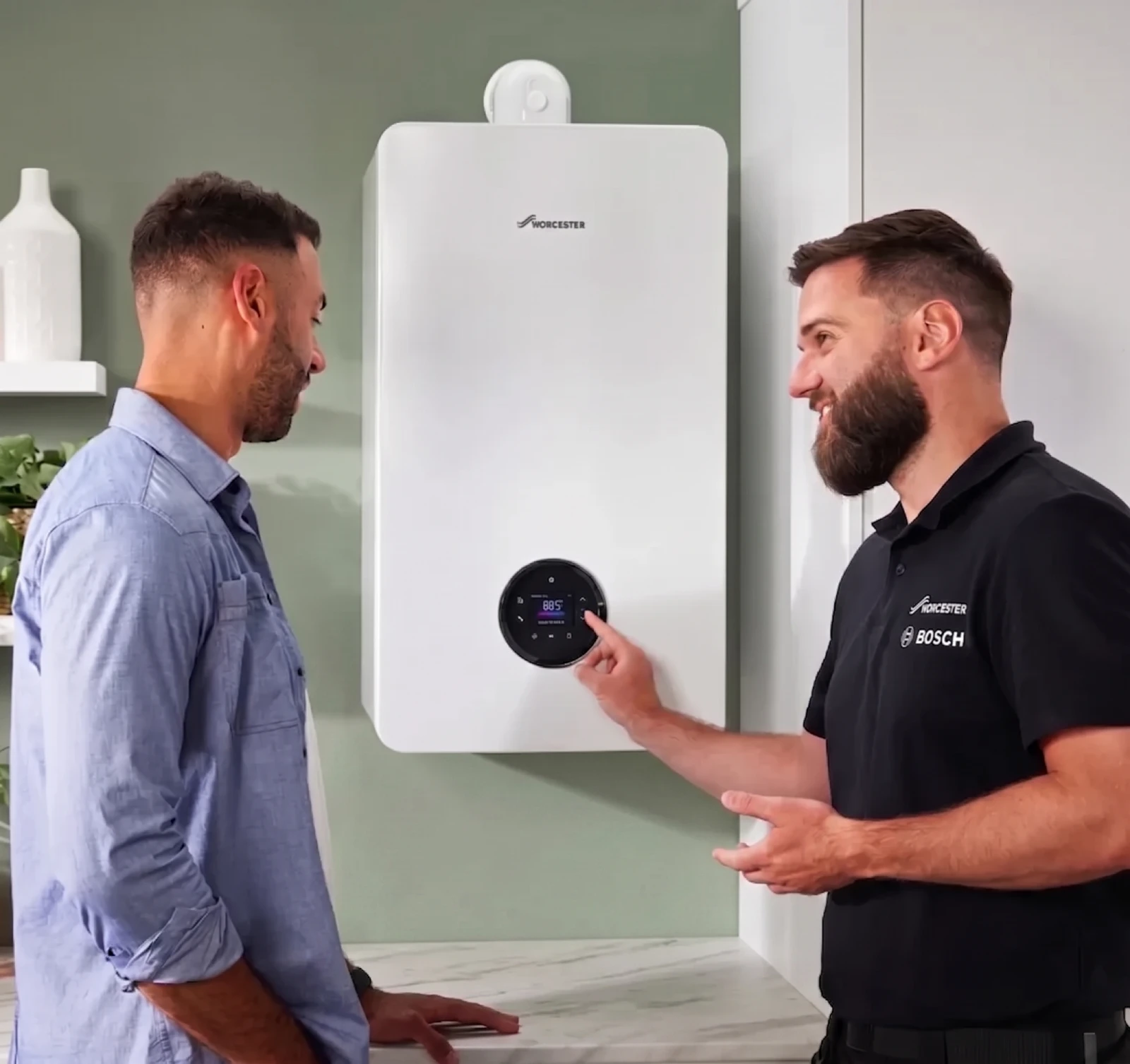 Engineer showing a customer their new boiler